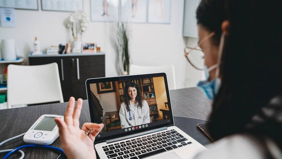 Two medical professionals having a conversation over a video call